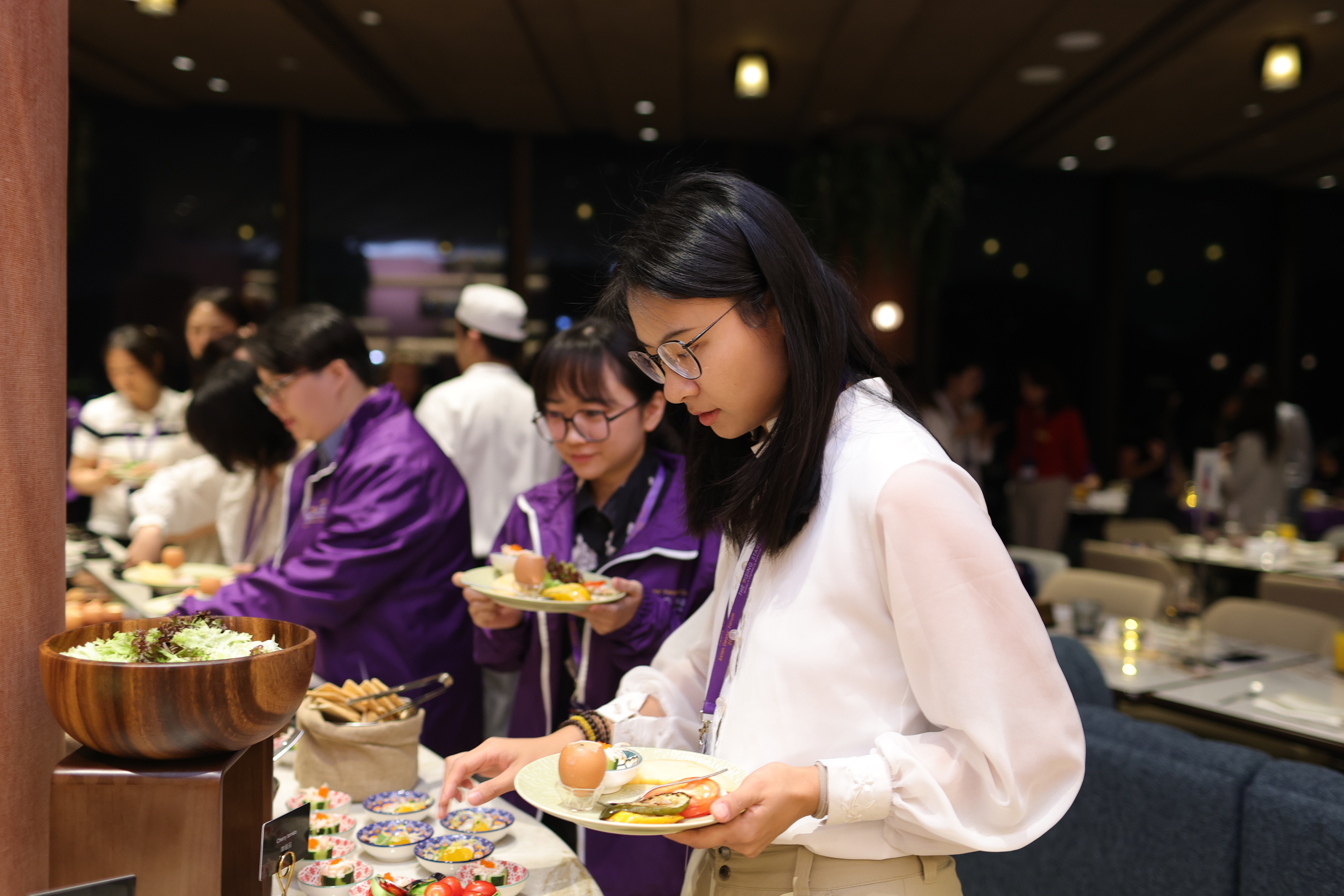 Participants gathering food and spending time together at the welcome mixer.