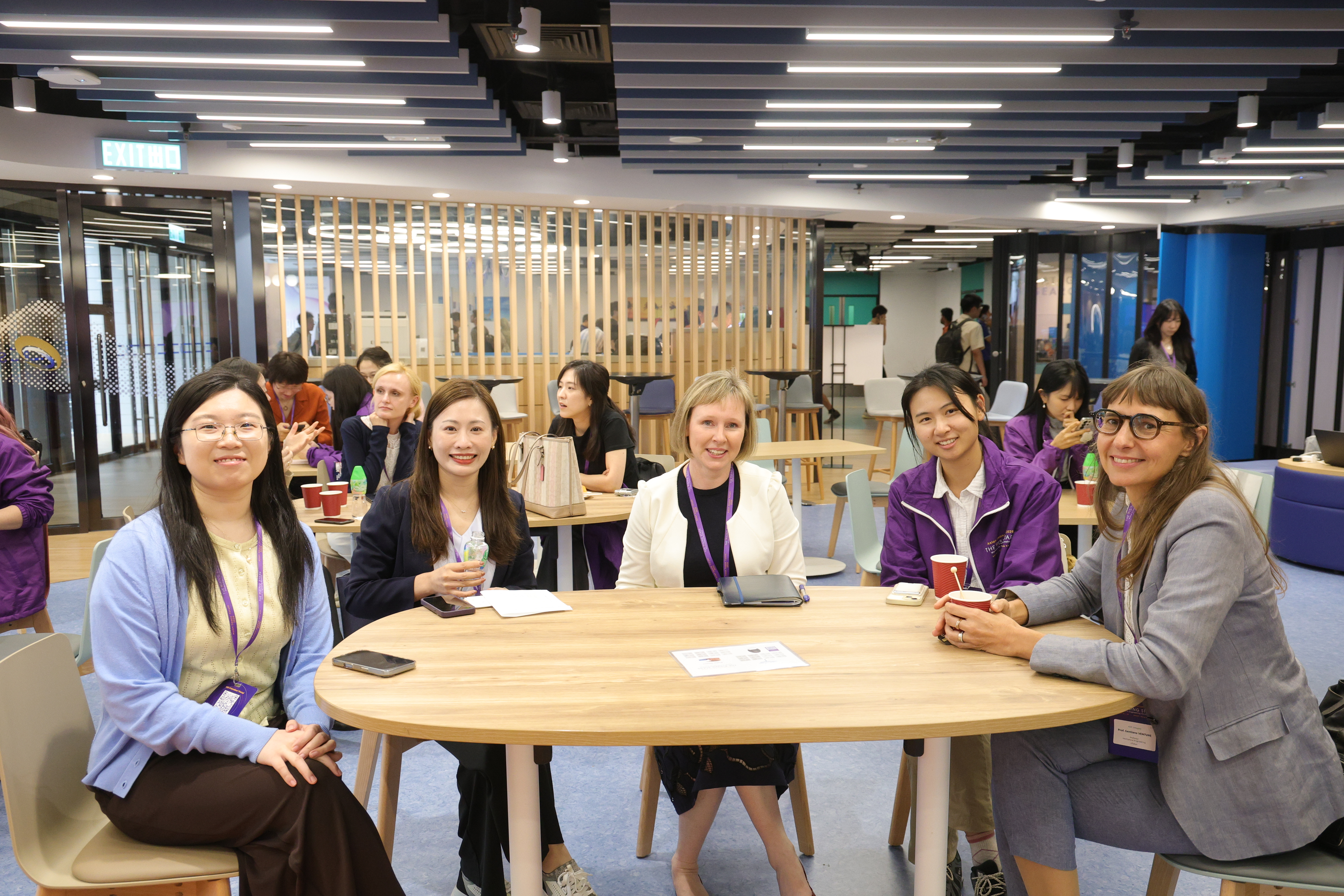 A group photo with fellow participants and faculty seated around a table.
